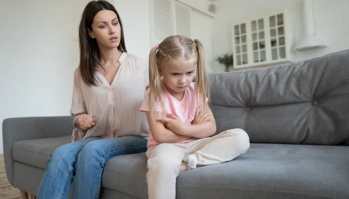 A child turned away from a caregiver, appearing indifferent to their presence.