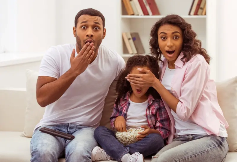 A parent and child sitting in awkward silence, unable to talk openly about sex.