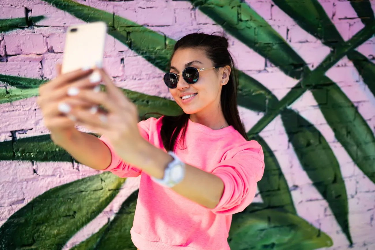 A social-media influencer filming content that models an idealized lifestyle for teen viewers.