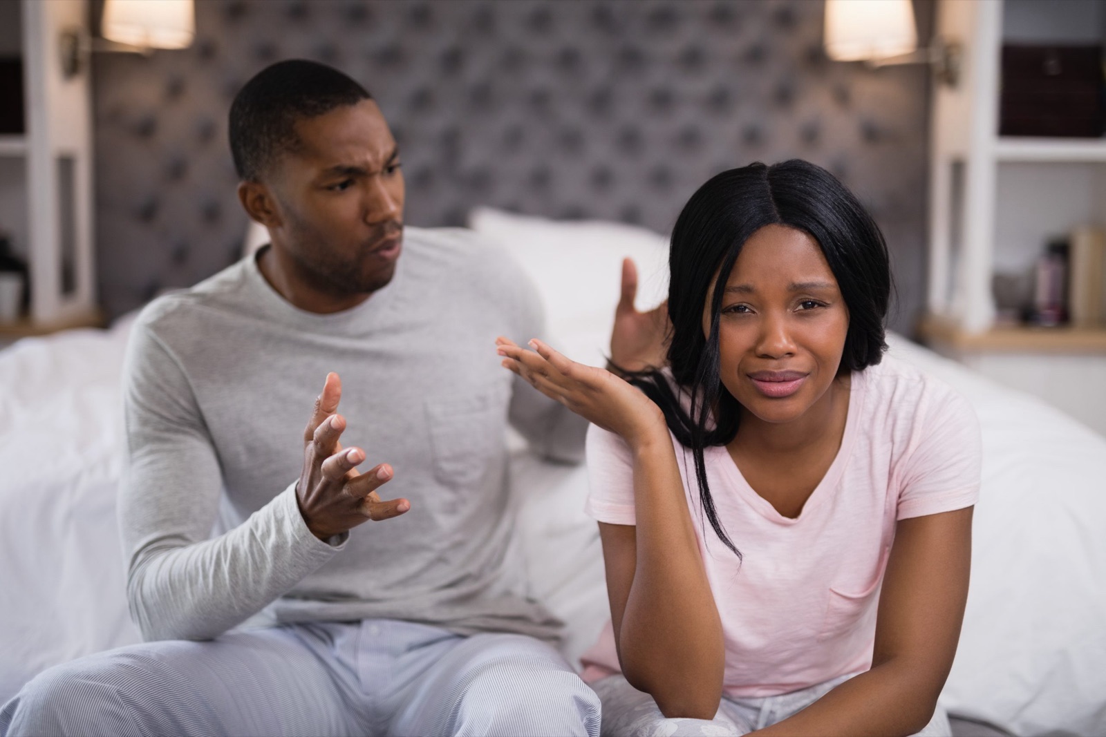A couple in the middle of a tense argument, turned away from each other.