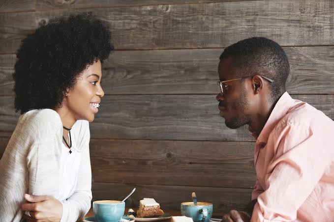 Two partners in close conversation, sharing personal thoughts and feelings.