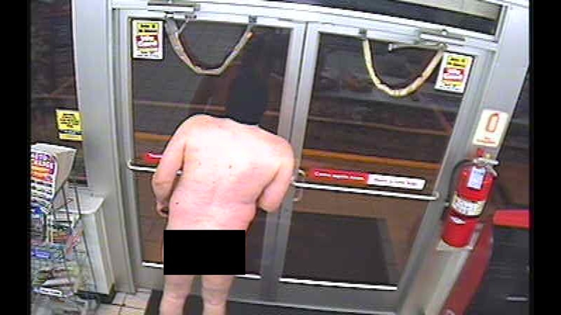 A figure in a long coat captured on CCTV, illustrating indecent exposure.