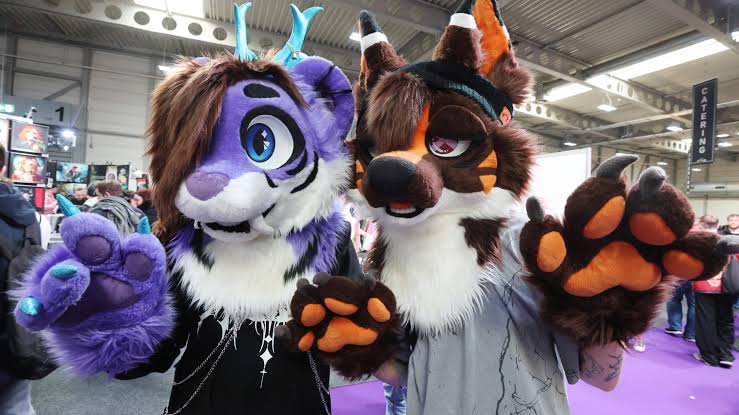 People in colorful animal costumes at a furry convention.