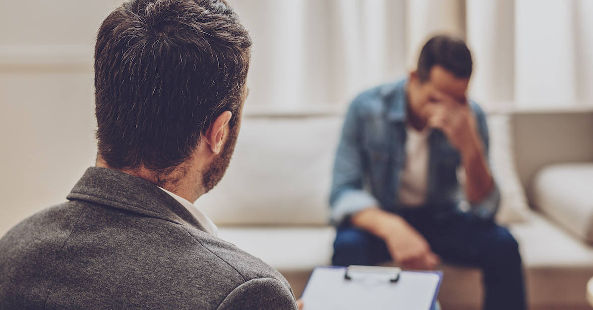 A therapist and client in conversation during a talk-therapy session.