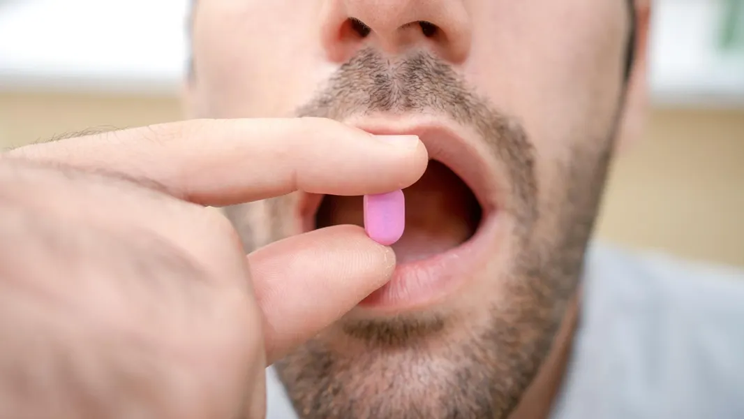 A handful of pills representing male contraceptive options in development.