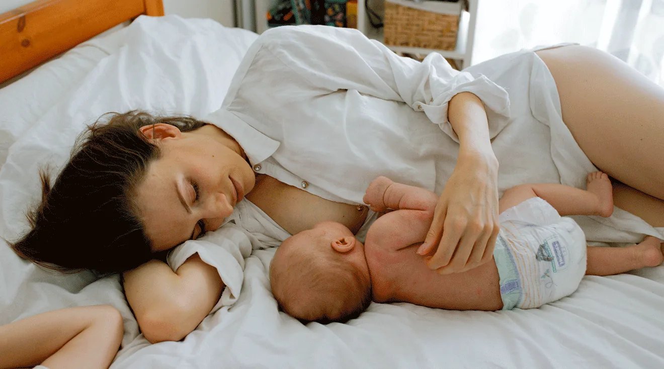 A parent breastfeeding a newborn.