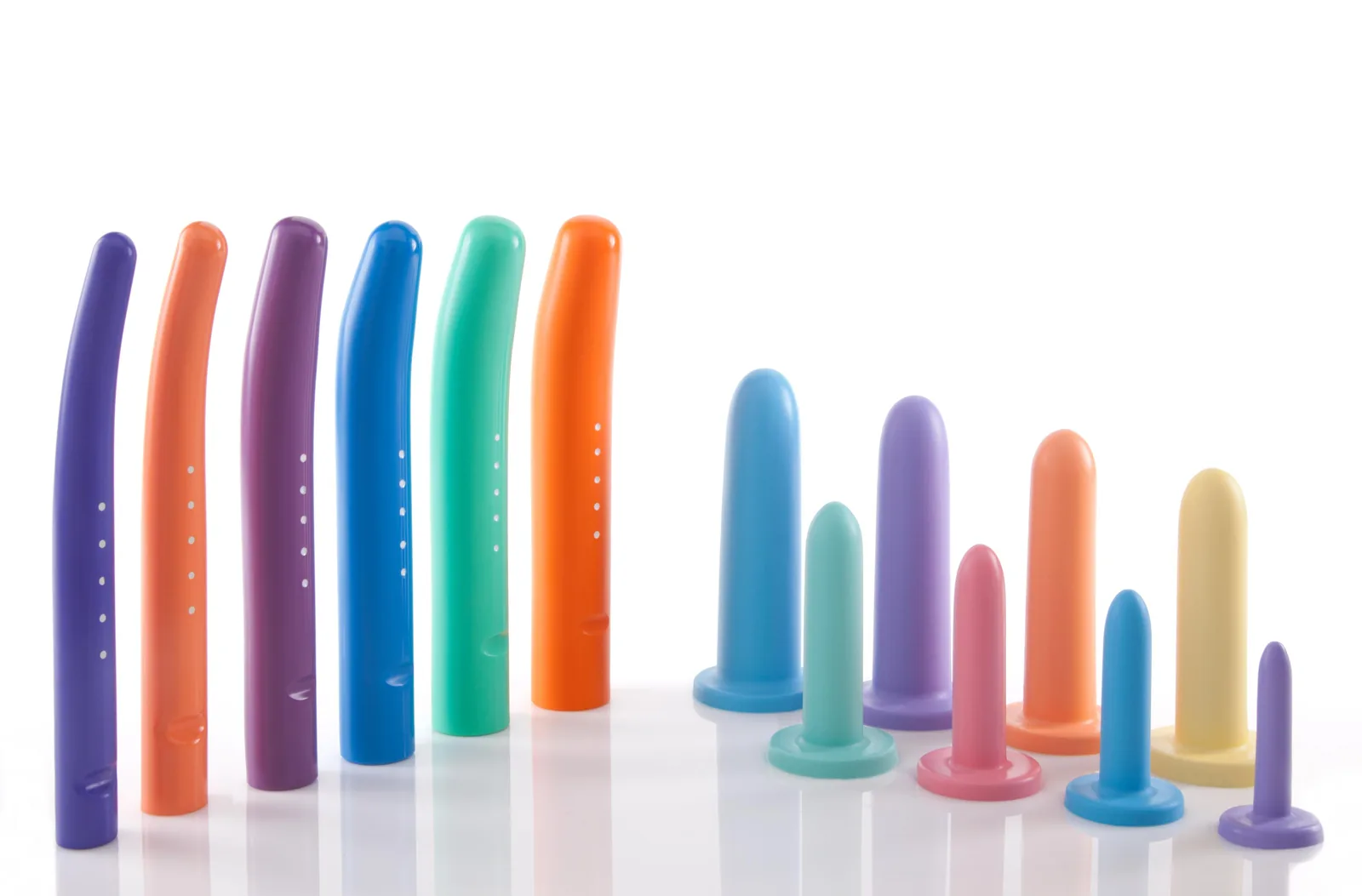Two graduated sets of vaginal dilators arranged by size.